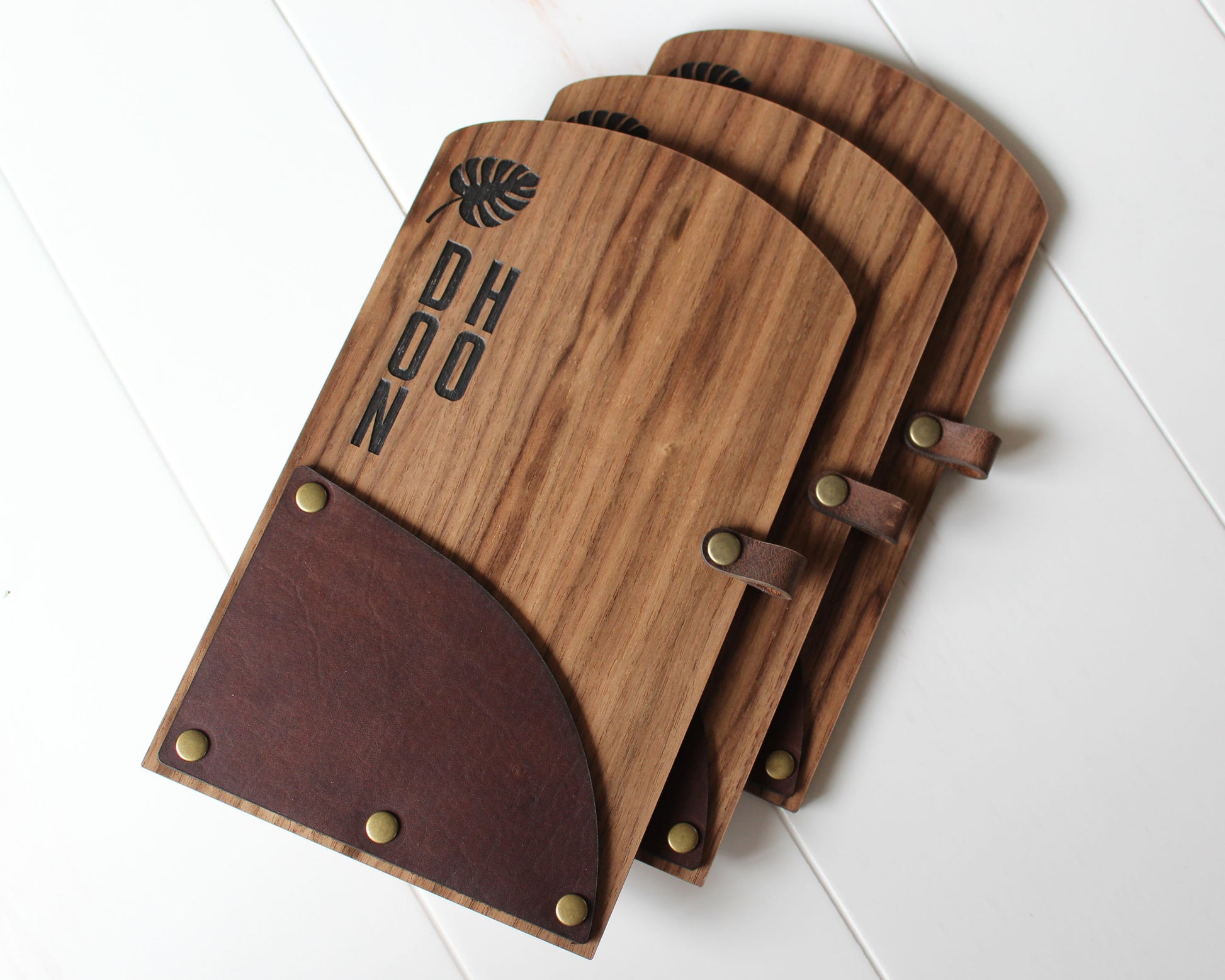 Engraved wood and leather check presenter with brass rivets