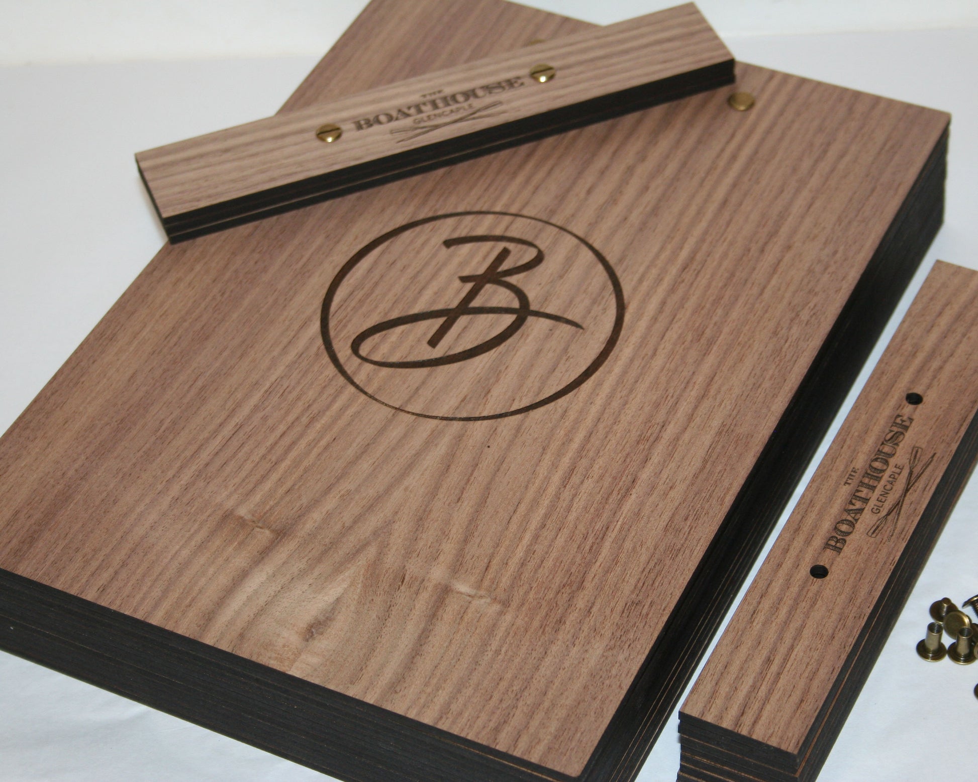 Custom walnut menu board engraved with restaurant logo