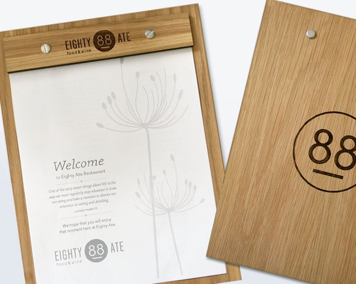Oak wood menu board engraved with restaurant logo