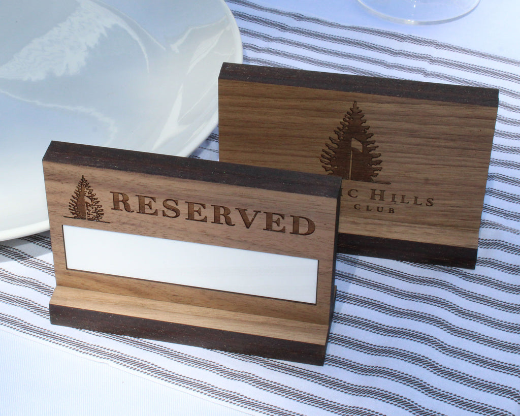Walnut table reserved sign with dry erase panel