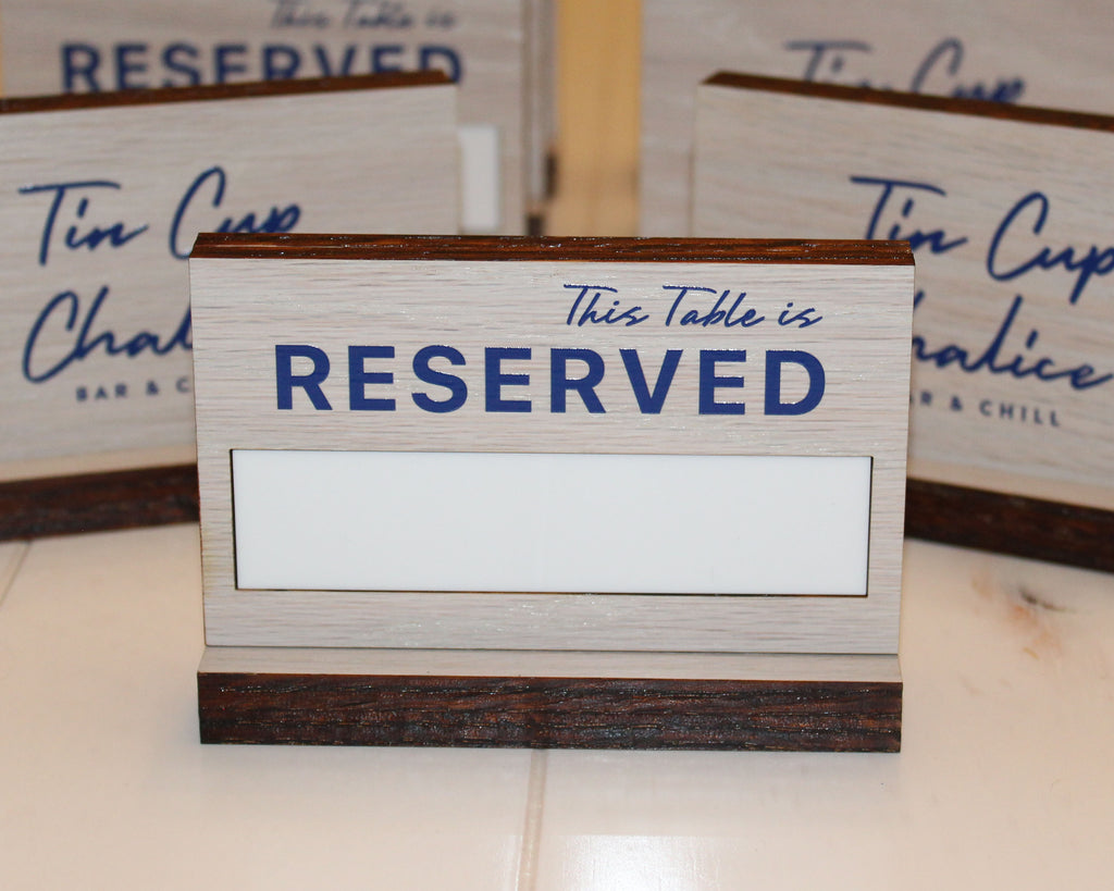 White stained  oak table reserved sign with colored UV Printing