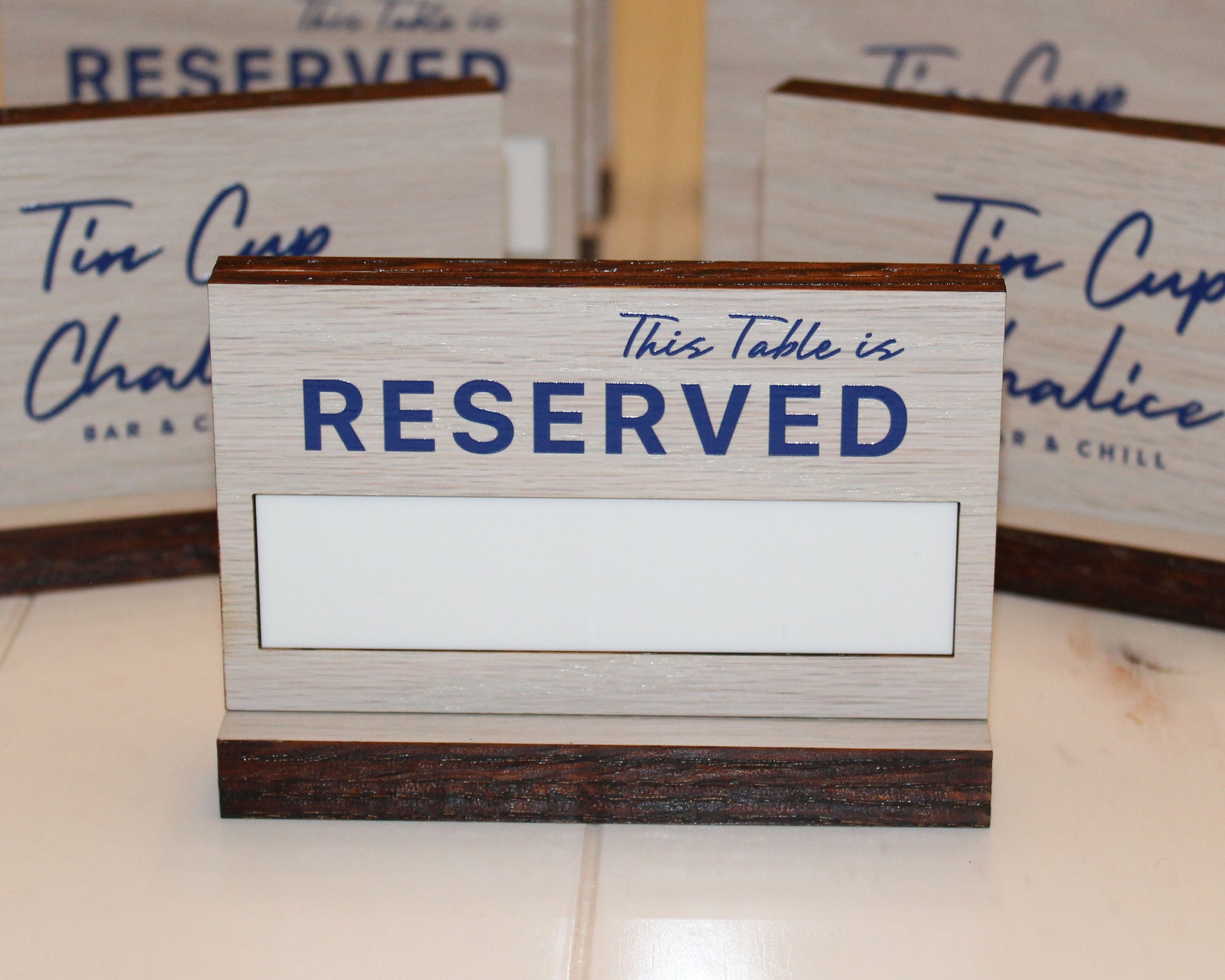 White stained  oak table reserved sign with colored UV Printing